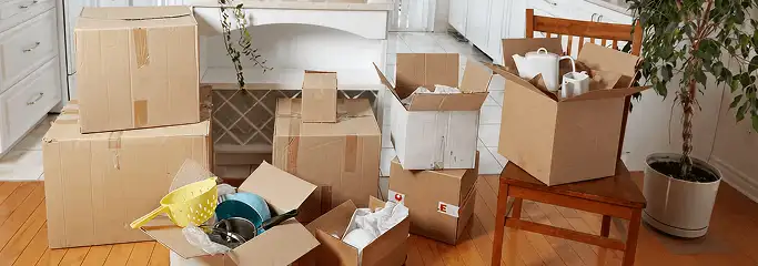 Packed moving boxes and household items in a kitchen before move-out or move-in cleaning, Cape Coral, FL.